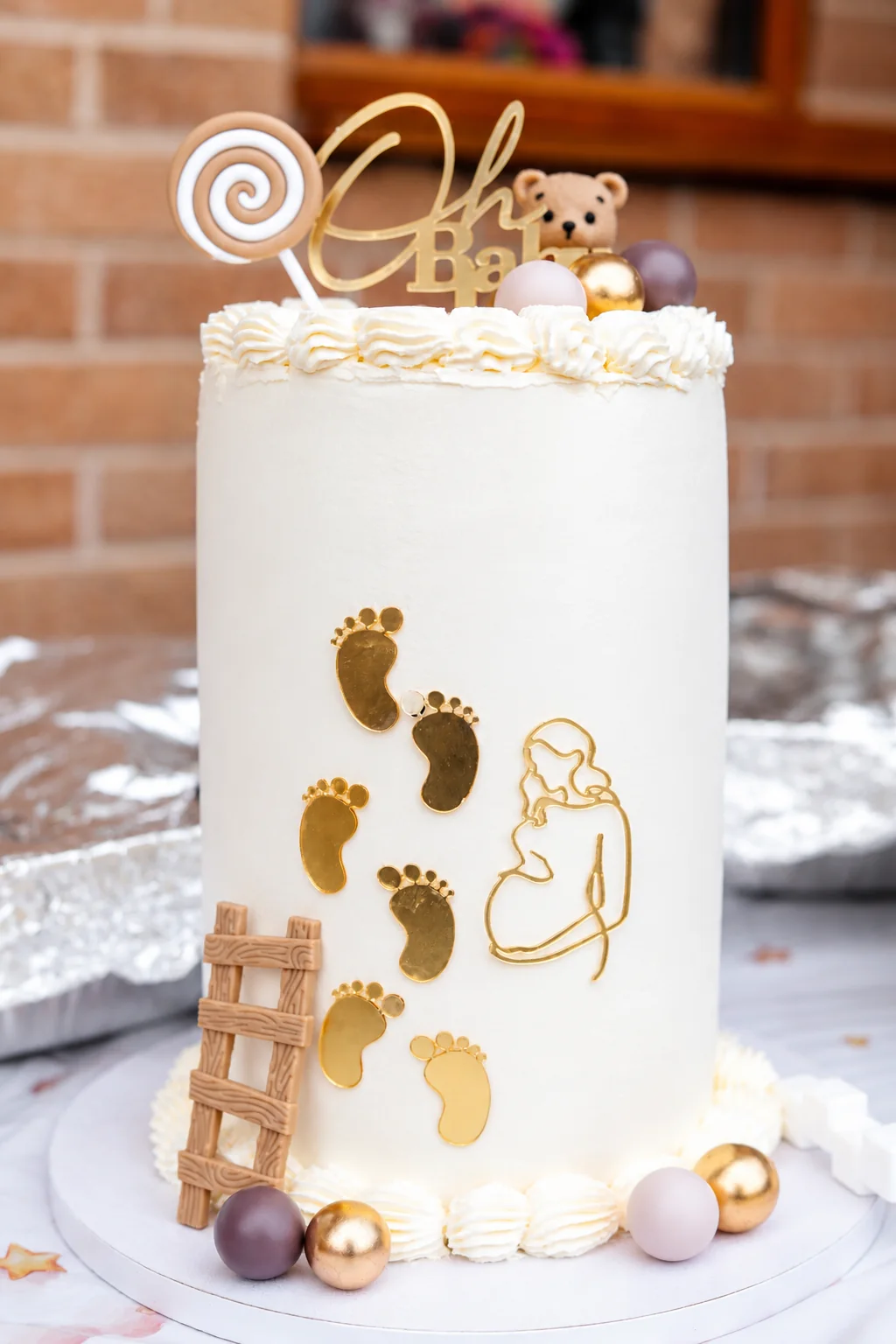 Baby shower cake with gold footprints
