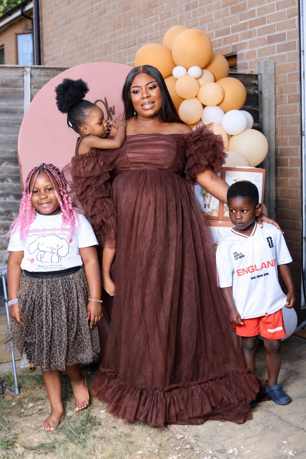 Family celebration portrait with coordinated brown outfits